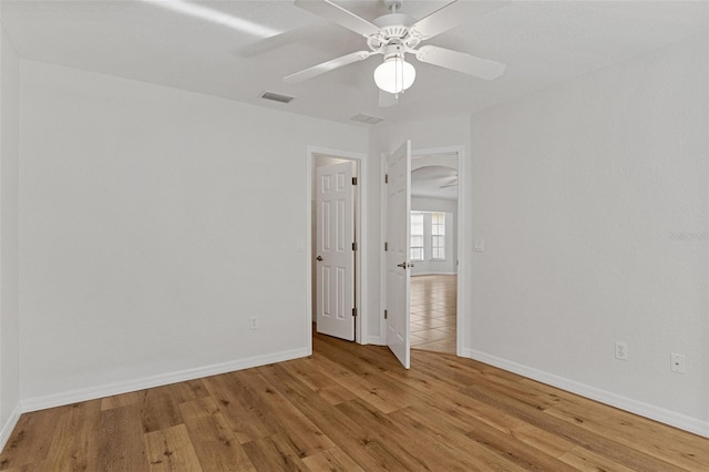 spare room featuring ceiling fan and light hardwood / wood-style flooring