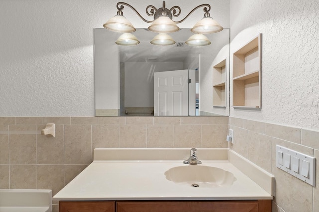 bathroom with vanity and tile walls