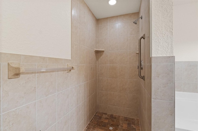 bathroom with a tile shower