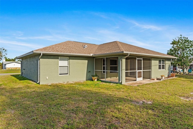 back of house with a sunroom and a yard