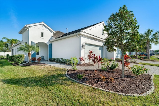 view of front of property with a garage and a front lawn