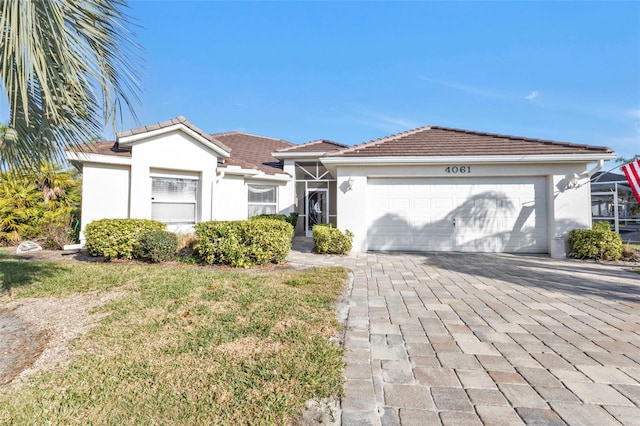 view of front facade with a garage and a front lawn