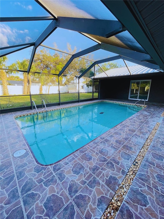 view of swimming pool with a lanai and a patio area