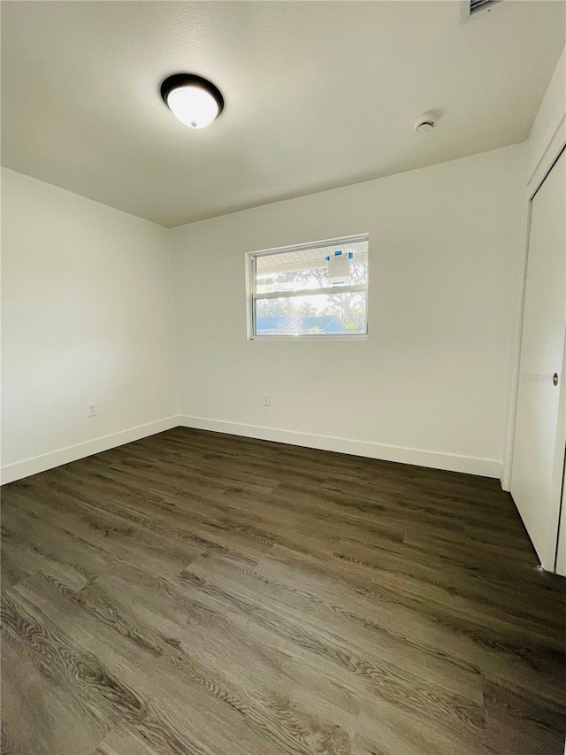 4128 Durant St, Port Charlotte, FL 33948 - spare room featuring dark wood-style flooring and a smoke detector