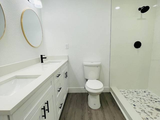 4128 Durant St, Port Charlotte, FL 33948 - bathroom featuring double vanity, wood finished floors, and a tile shower