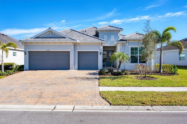 view of front of house featuring a garage and a front yard