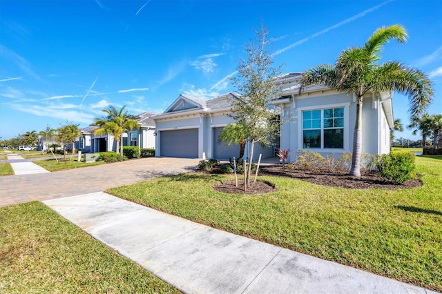 view of front of home featuring a garage and a front lawn