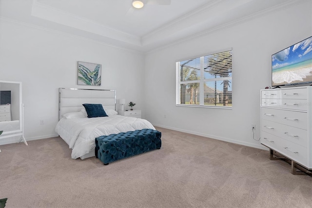 carpeted bedroom with crown molding, ceiling fan, and a tray ceiling