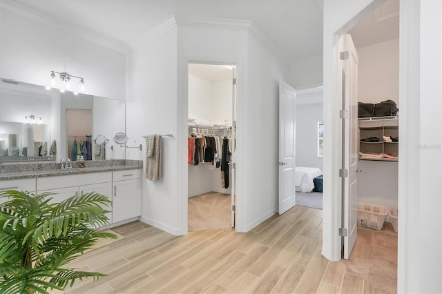 bathroom featuring vanity and ornamental molding