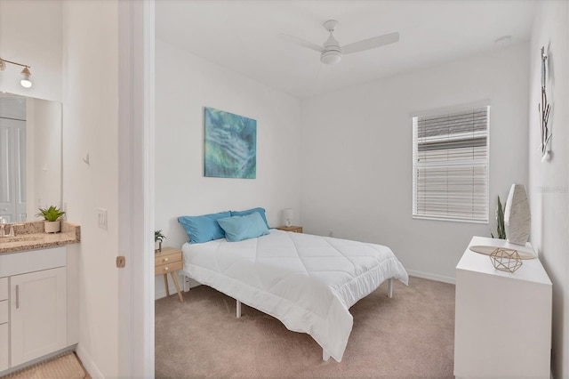 bedroom with ceiling fan, light colored carpet, and sink