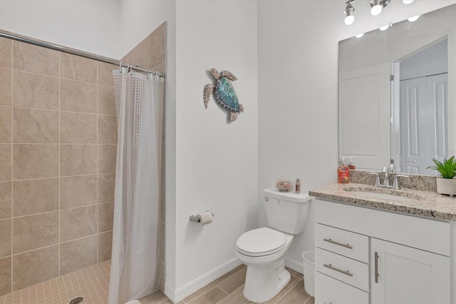 bathroom featuring vanity, toilet, and curtained shower