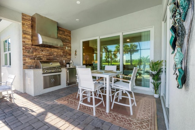 view of patio with area for grilling and a grill