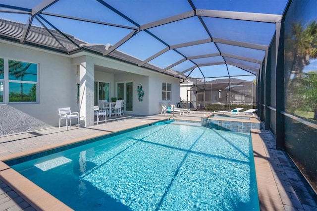 view of swimming pool with an in ground hot tub, a lanai, and a patio