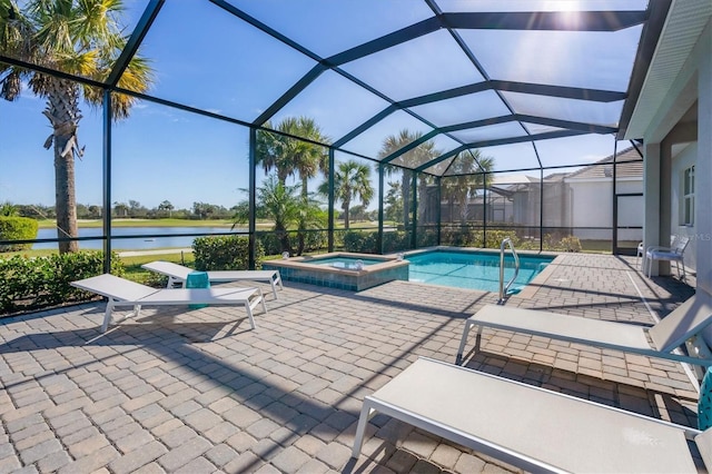 view of swimming pool with a patio, a lanai, a water view, and an in ground hot tub