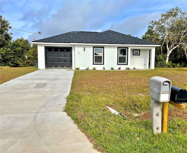 view of front of property with a garage and a front yard