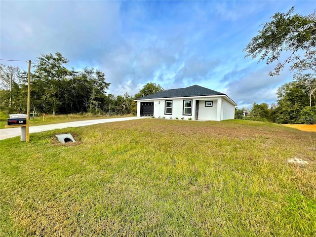 view of front facade with a garage and a front lawn