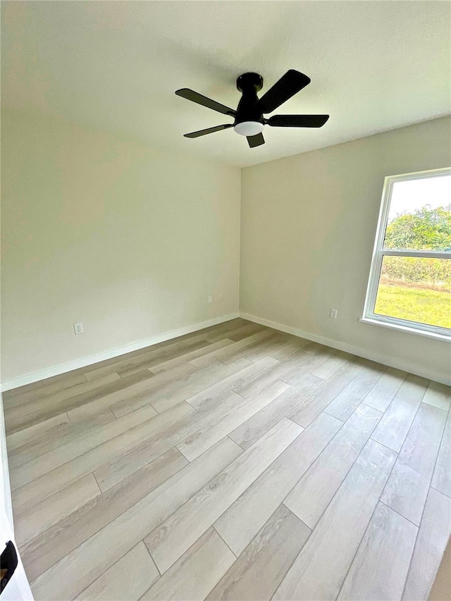 spare room featuring light hardwood / wood-style flooring and ceiling fan