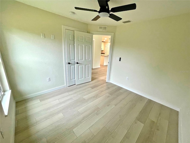 unfurnished bedroom featuring ceiling fan and light hardwood / wood-style floors