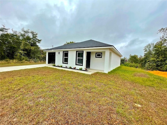 view of front of home with a garage and a front lawn