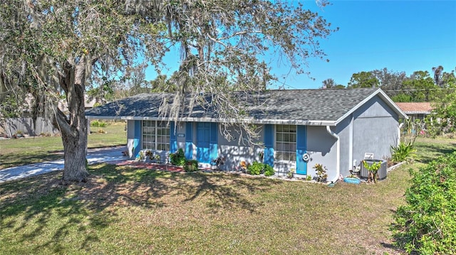 ranch-style house featuring central AC and a front yard