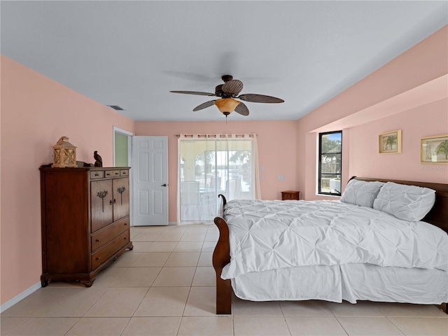 bedroom with multiple windows, light tile patterned floors, and ceiling fan