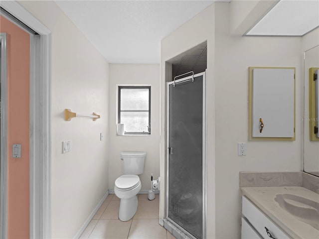 bathroom featuring vanity, a shower with shower door, tile patterned floors, and toilet