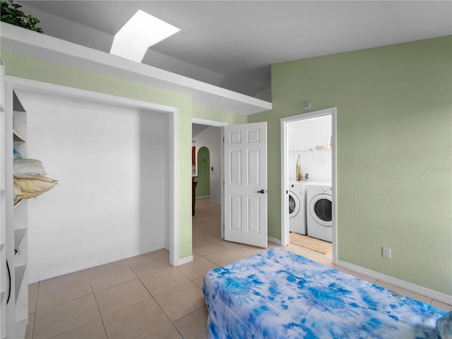 tiled bedroom with washing machine and dryer