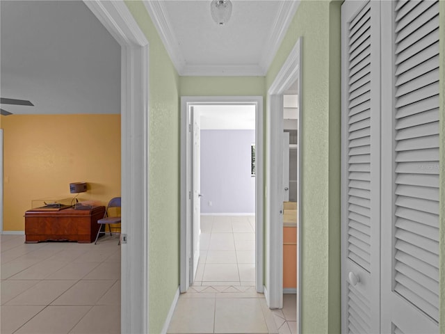 hall with ornamental molding and light tile patterned floors