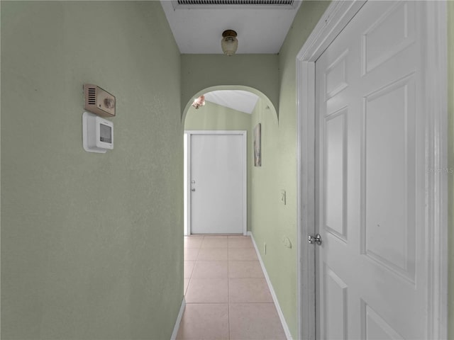 hall with light tile patterned floors