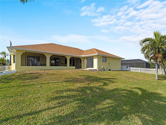 back of house with a lawn