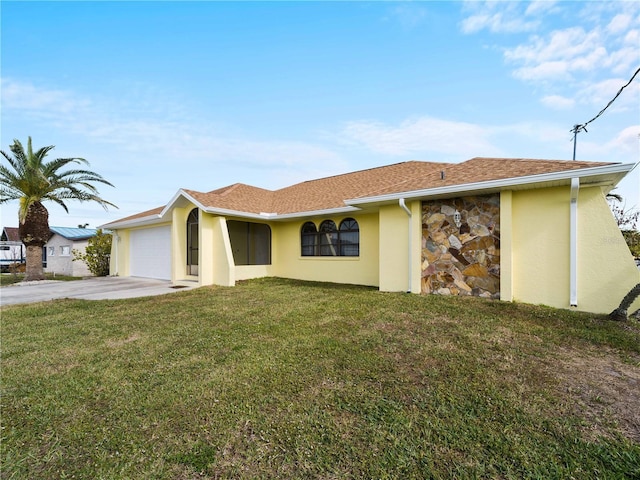 ranch-style home featuring a garage and a front lawn