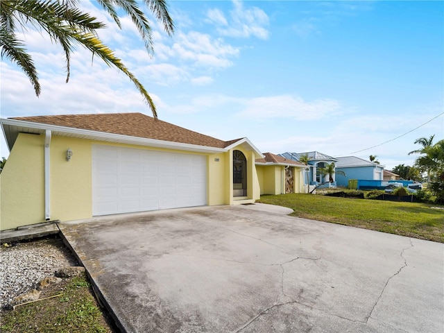 single story home with a garage and a front yard