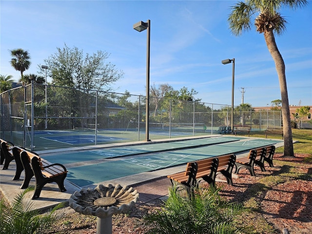 view of sport court featuring fence and shuffleboard