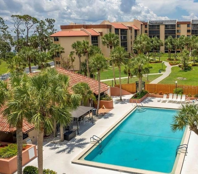 pool featuring a patio area and fence