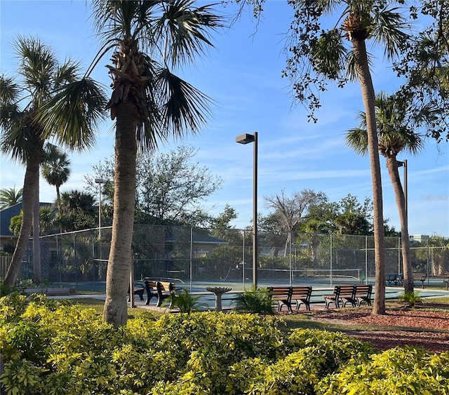 view of tennis court featuring fence