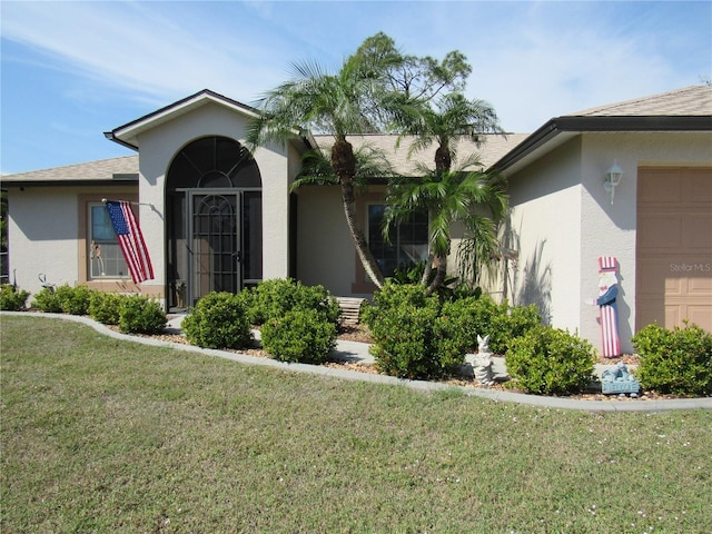 exterior space with a garage and a front lawn