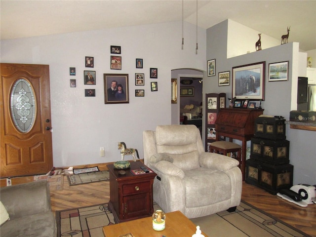 living room featuring hardwood / wood-style floors and vaulted ceiling