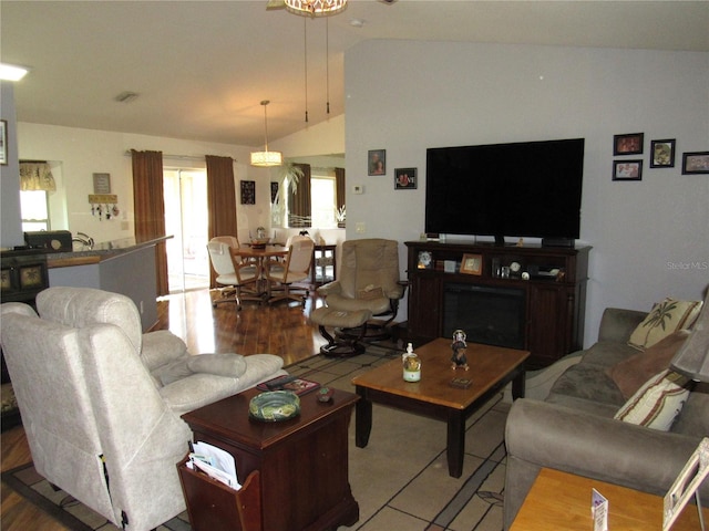 living room featuring lofted ceiling