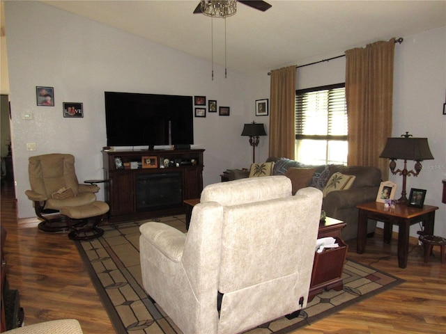 living room featuring hardwood / wood-style flooring, ceiling fan, and lofted ceiling