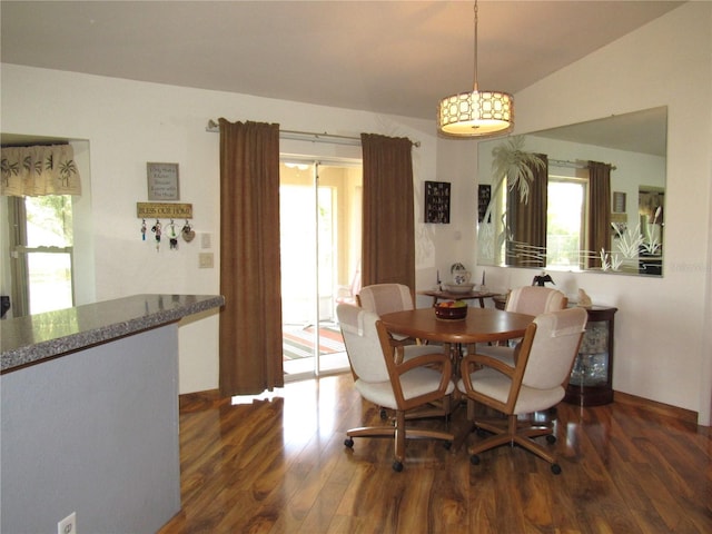 dining room with lofted ceiling and dark hardwood / wood-style floors