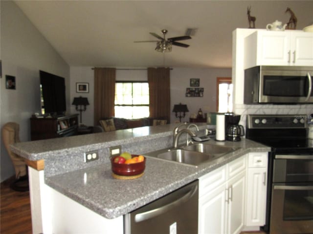 kitchen with appliances with stainless steel finishes, dark hardwood / wood-style floors, sink, white cabinets, and ceiling fan