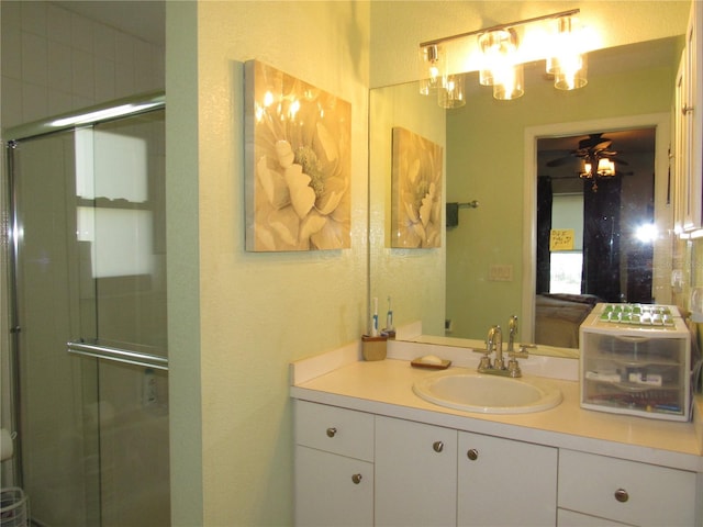 bathroom featuring vanity, ceiling fan, and walk in shower