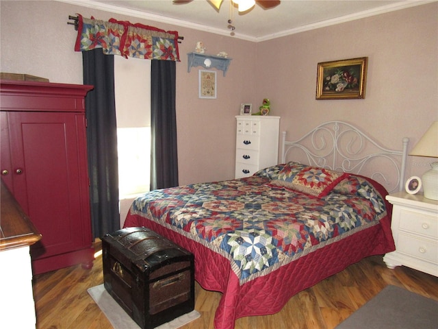 bedroom with wood-type flooring, ornamental molding, and ceiling fan