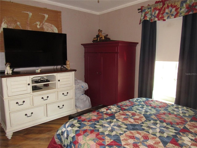 bedroom featuring crown molding and dark hardwood / wood-style floors