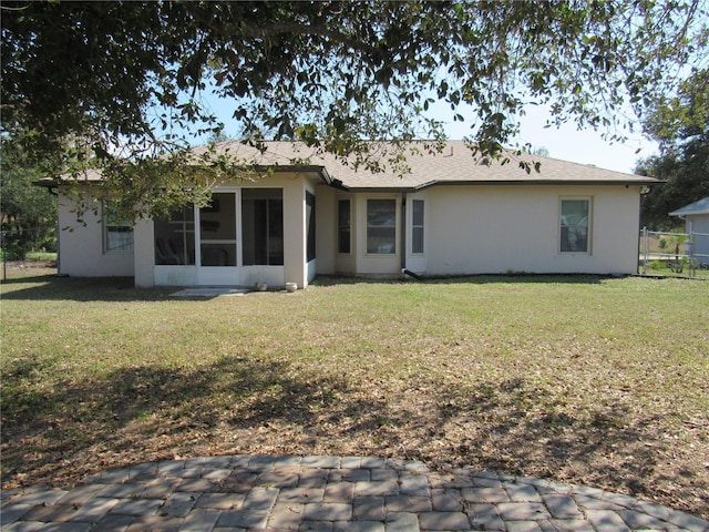 rear view of property featuring a yard