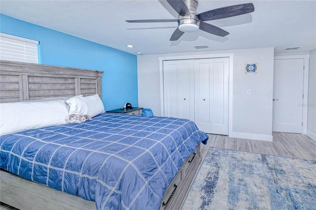 bedroom featuring ceiling fan, a closet, and light wood-type flooring