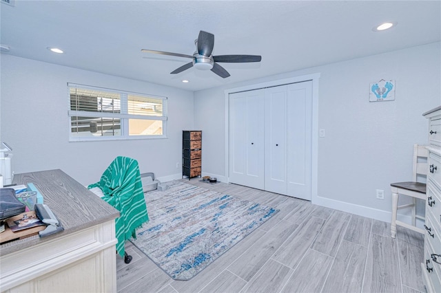 office area with ceiling fan and light hardwood / wood-style floors