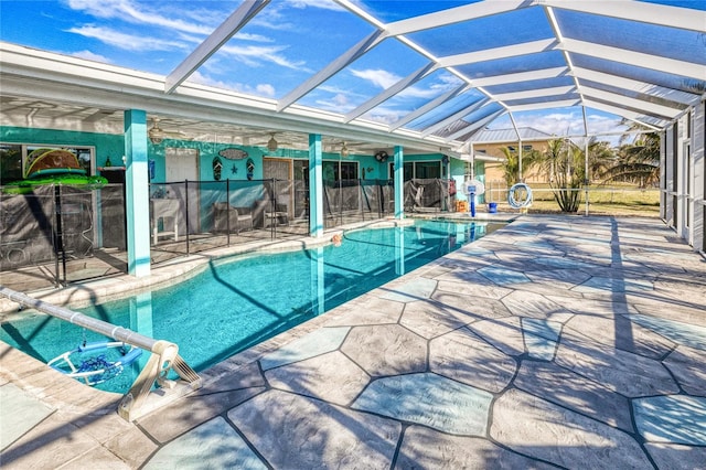 view of pool featuring glass enclosure and a patio area