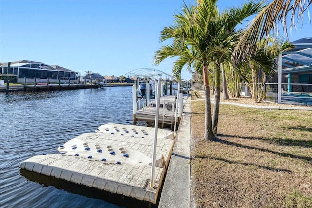 view of dock with a water view, a yard, and a lanai