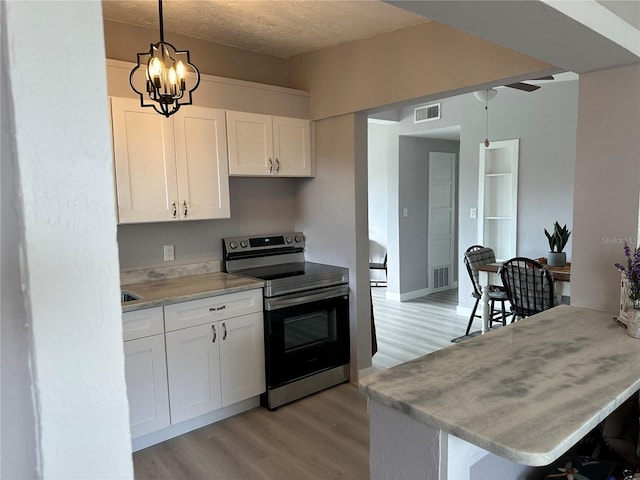 kitchen with white cabinetry, decorative light fixtures, kitchen peninsula, and stainless steel range with electric stovetop